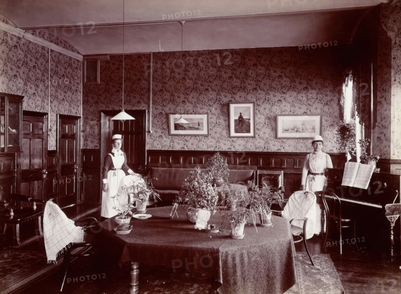 Claybury Asylum, Woodford, Essex: a social room (?) , [1893?]. Creator: London & County Photographic Co.