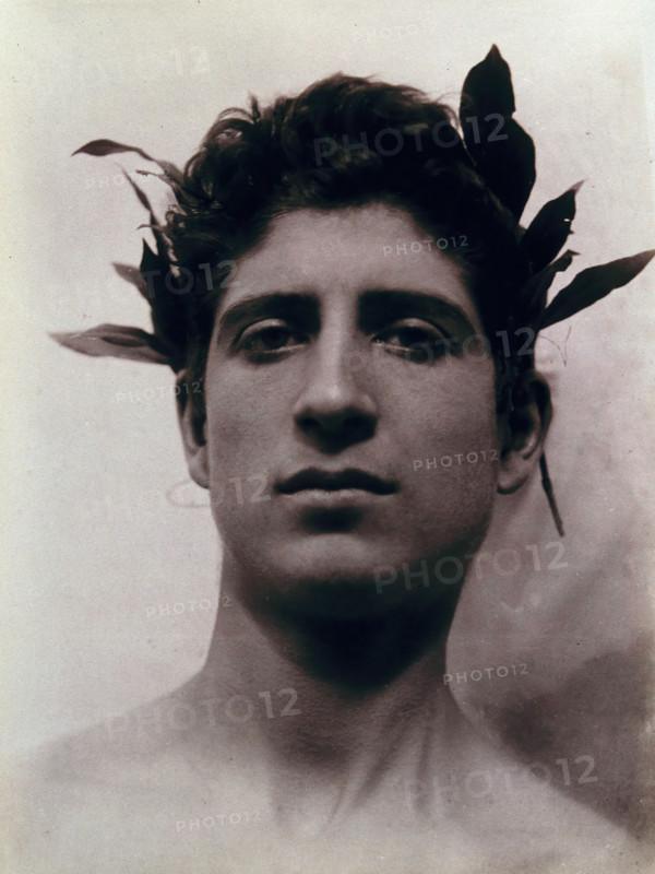 Head of a Sicilian boy posing, crowned with laurel leaves, March 1902. Creator: Count Wilhelm von Gloeden.