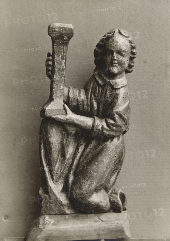 Kneeling figure with a candlestick, (1925-1930).  Creator: Unknown.