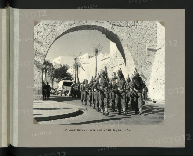 A Sudan Defence Force unit enters Tripoli, 1943. Showing Tripoli Castle on Piazza Italia. Creators: Colonial Office, Unknown.