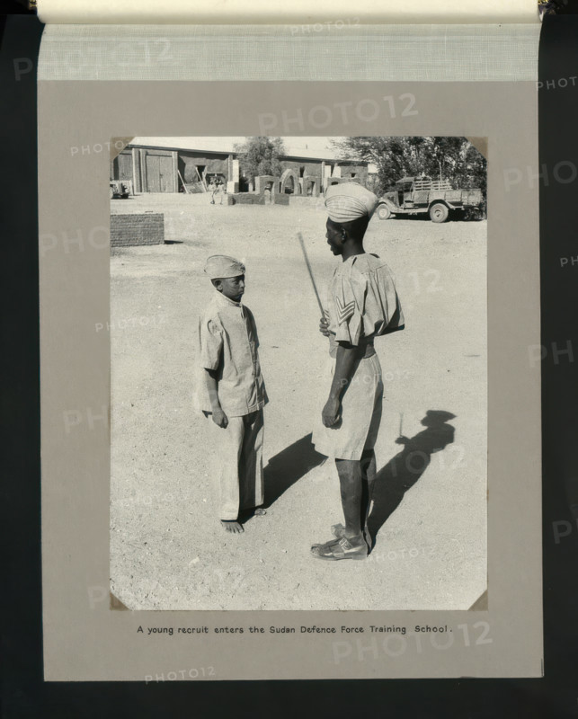 A young recruit enters the Sudan Defence Force Training School, 1964. Creators: Colonial Office, Unknown.
