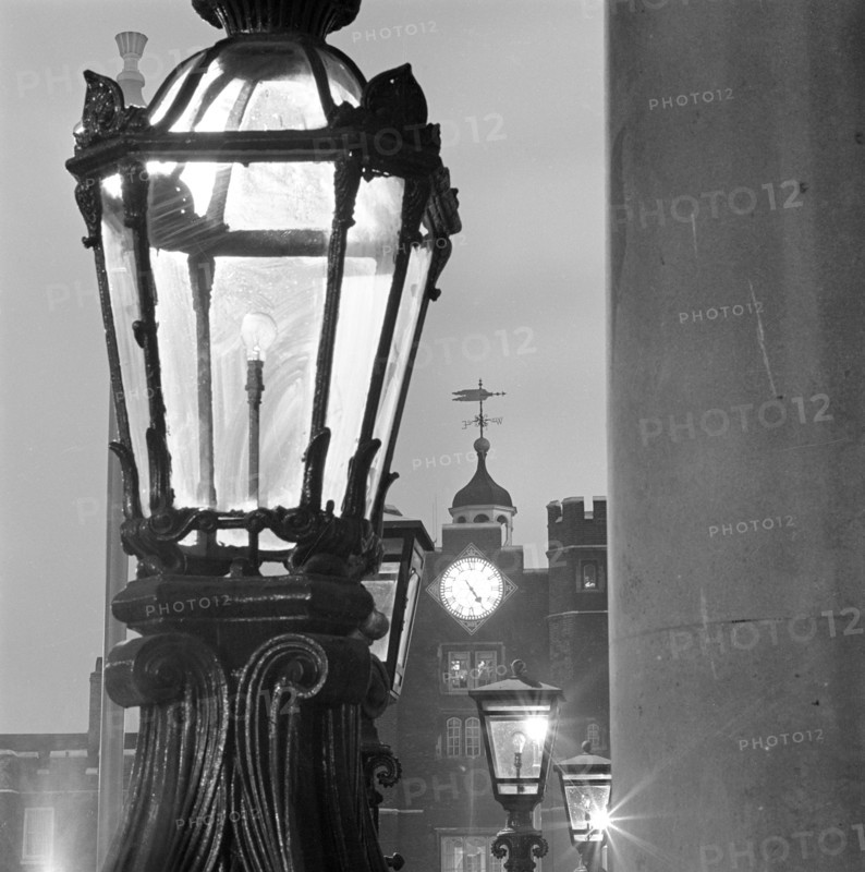 Street lamps at dusk, with the gatehouse of St James's Palace, City of Westminster, London, 1982. Creator: John Gay.