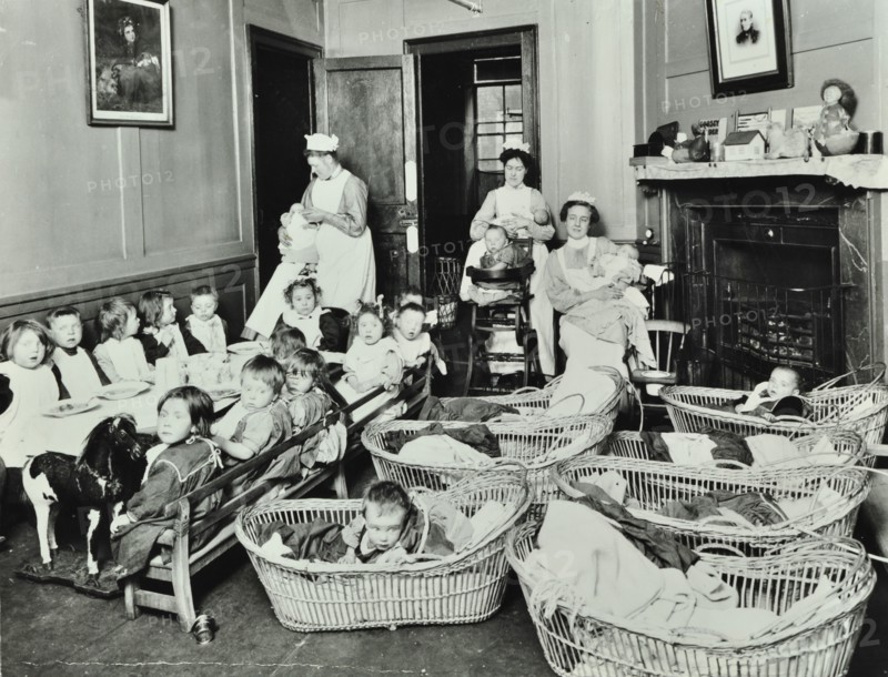 30 Albury Street; Nursey at dinner time, Children in Baskets, 1911. Creator: Unknown.