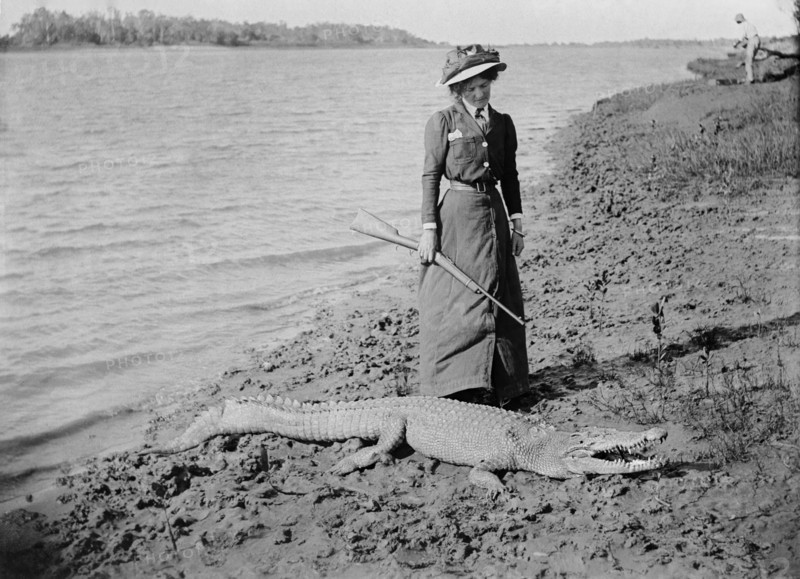 Unknown lady with rifle and a saltwater crocodile, 1910. Creator: Robert Augustus Henry L'Estrange.
