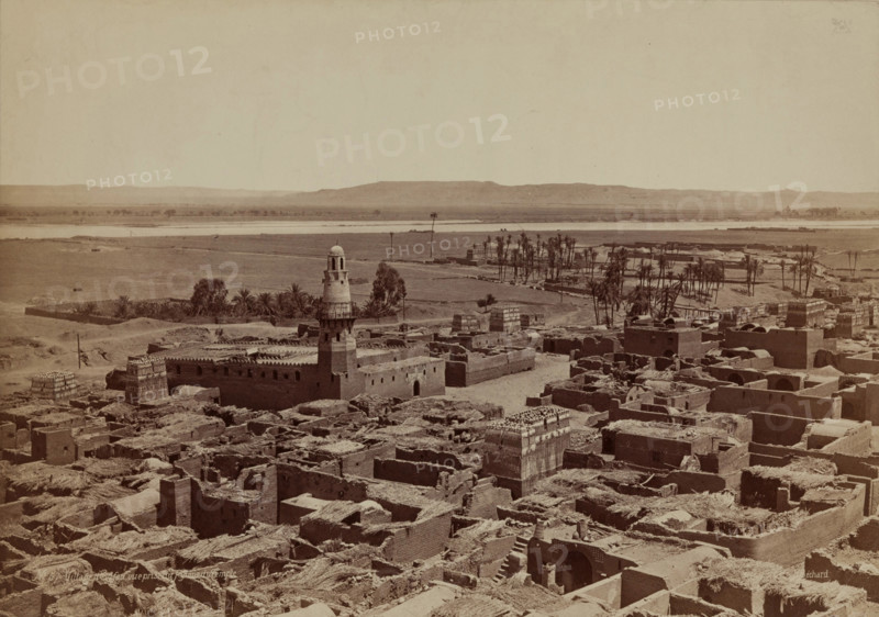 Village of Edfu, View Taken from the Pylon of the Temple, late 19th century. Creator: Henri Bechard.