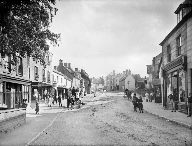 Looking up Church Street with people in the street and outside shop premises, Charlbury, Oxon, 1888. Creator: Henry Taunt.