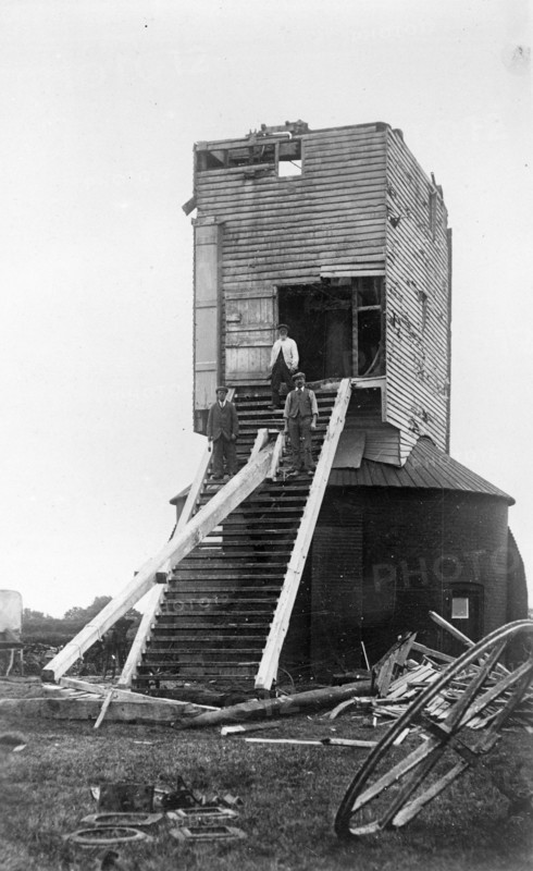 Three men standing on the remains of Golden Cross Windmill, Chiddingly, East Sussex, 1935.  Creator: HES Simmons.