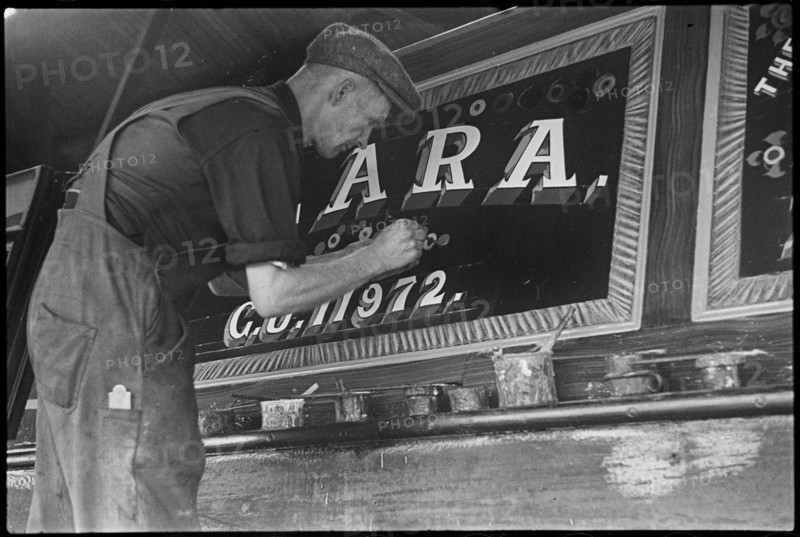 Barge painter Frank Jones, of 3 Edward Street, at work, Leighton Buzzard, Bedfordshire, 1910-60. Creator: George R Long.