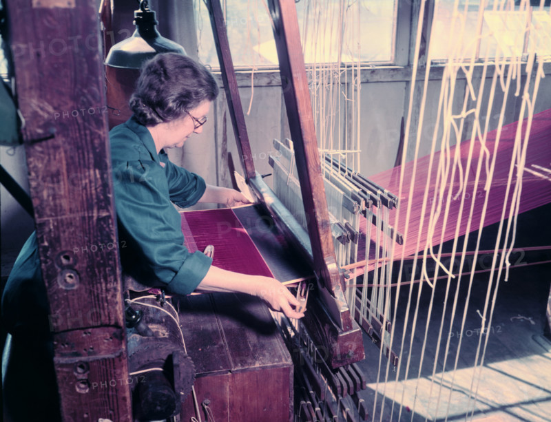 Women at a loom weaving cloth for state robes to be worn at the coronation of Elizabeth II, 1953. Creator: Arthur Charles Kirby Ware.