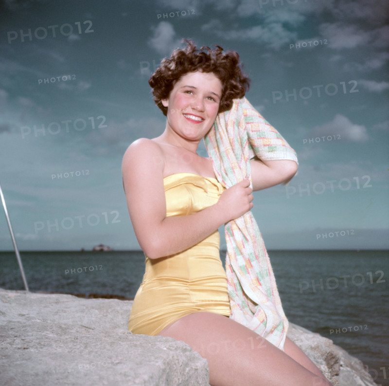 Portrait of a young woman in a swimsuit by the sea, c1955. Creator: Arthur Charles Kirby Ware.