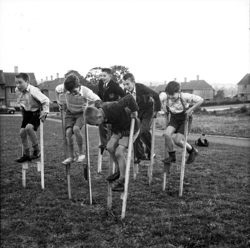 Children walking on stilts, c1955. Creator: Arthur Charles Kirby Ware.