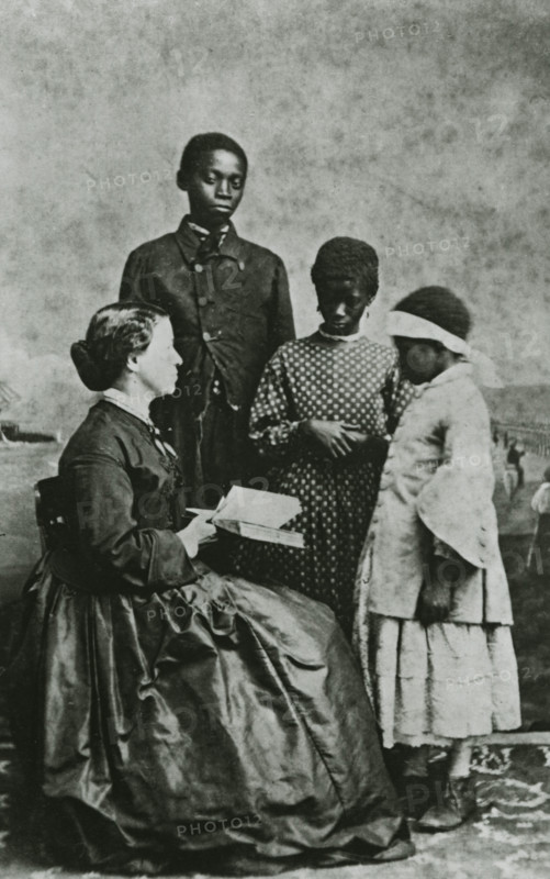 Portrait of teacher Laura M. Towne, a founder of the Penn School, with students..., February 1866. Creator: Unknown.