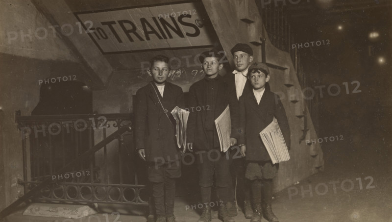 Four Newsies at an Entrance to the Subway, New York City, 1910. Creator: Lewis Wickes Hine.