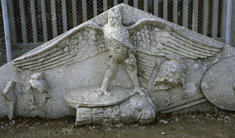 Eagle figure, armour, spear, helmet and circular shield, Roman gable, Side, Turkey, 1999. Creator: LTL.