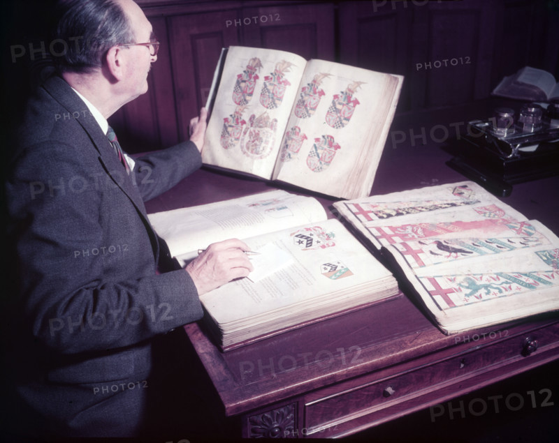 Mr. Mitchell (Herald Painter) in Records Room, College of Arms, London, c1953. Creator: Arthur Charles Kirby Ware.