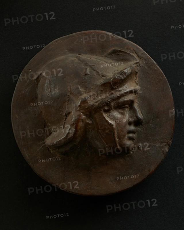 Cast of head of full-faced, young Roman soldier in helmet. Creator: Unknown.