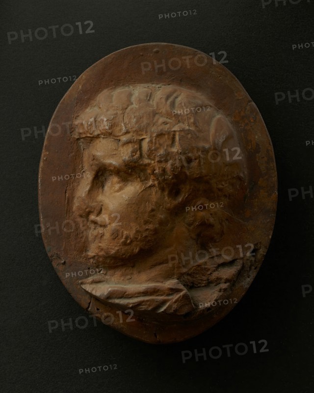 Cast of head of bearded Roman official wearing cloak. Creator: Unknown.