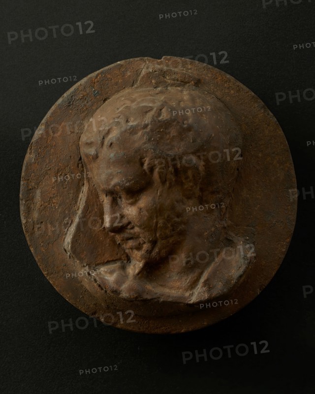 Cast of head of oarsman looking down, with vertical edge of building behind. Creator: Unknown.