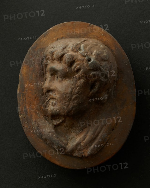 Cast of head of lightly-bearded man wearing wreath (?) and with mouth open. Creator: Unknown.