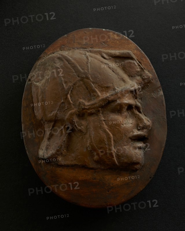 Cast of head of Eastern archer with helmet. Creator: Unknown.