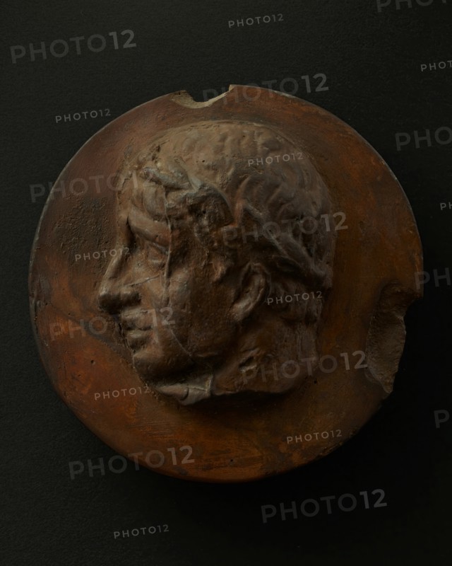 Cast of clean-shaven Roman man wearing a wreath. Creator: Unknown.