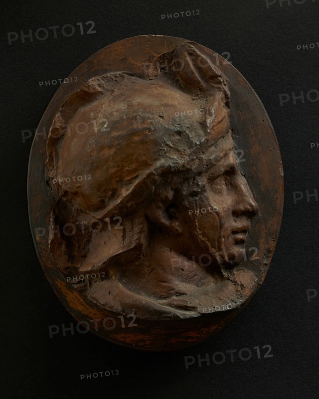 Cast of head of young auxiliary wearing a helmet. Creator: Unknown.