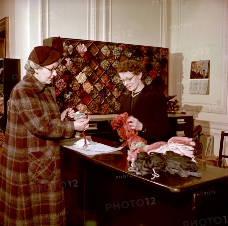 Choosing wools at the shop counter, Royal School of Needlework, c1955. Creator: Arthur Charles Kirby Ware.
