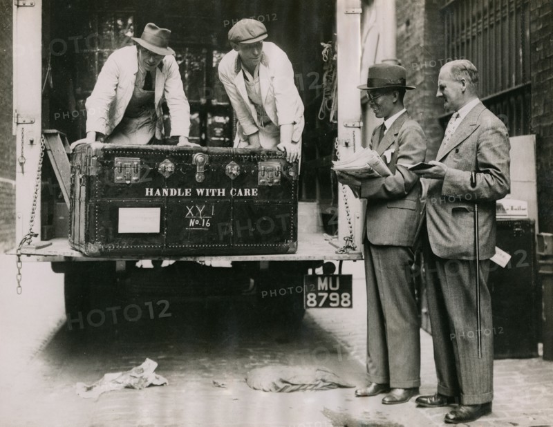 Sir Walter Lamb and Zhuang Shangyan (Chuang Shang-yen) checking cases as they arrive at..., 1935.  Creator: Topical Press Agency.