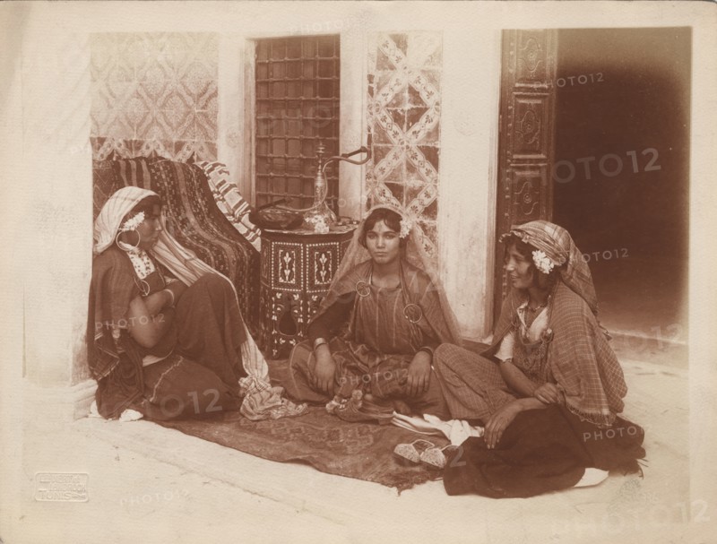 Three young women sitting by a doorway, Tunis, c1910. Ernst Heinrich Landrock, (1878-1966) Creator: Lehnert & Landrock.