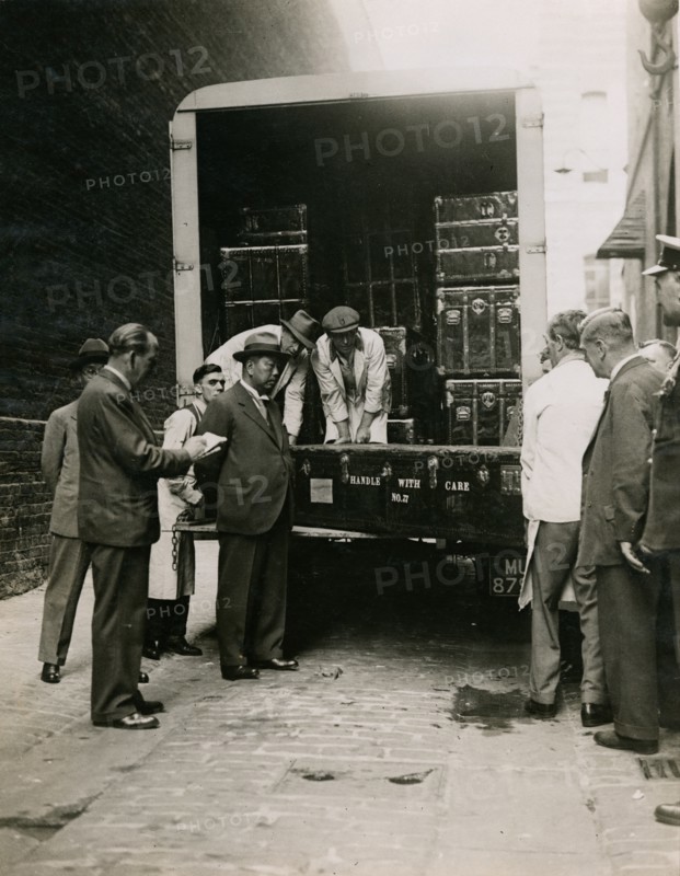 Zheng Tianxin (Dr Cheng) watching the unloading of cases in the West Yard at Burlington House, 1935. Creator: Topical Press Agency.