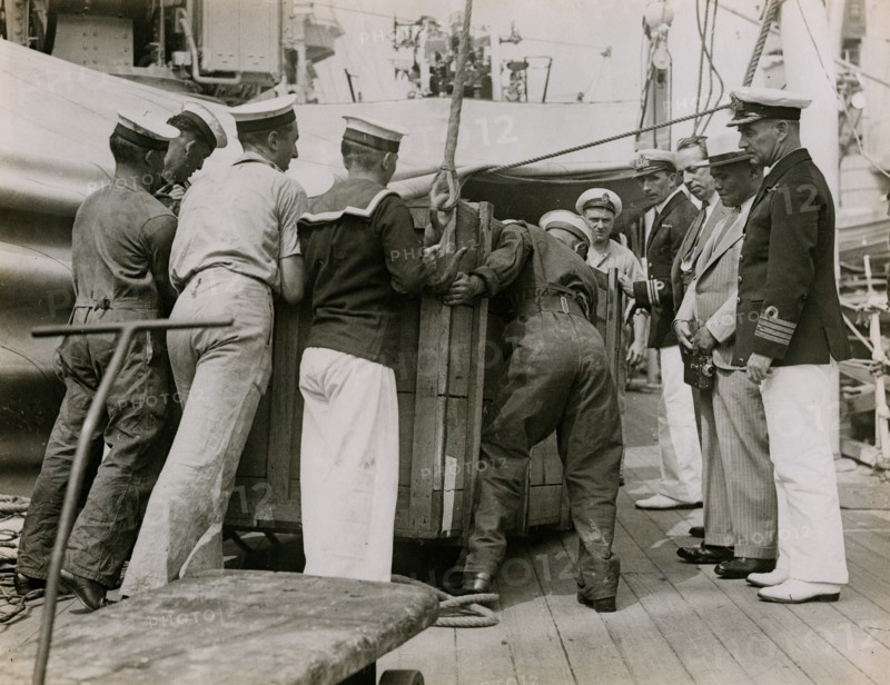 Unloading a case from H.M.S. Suffolk at Portsmouth, July 1935. Creator: Topical Press Agency.