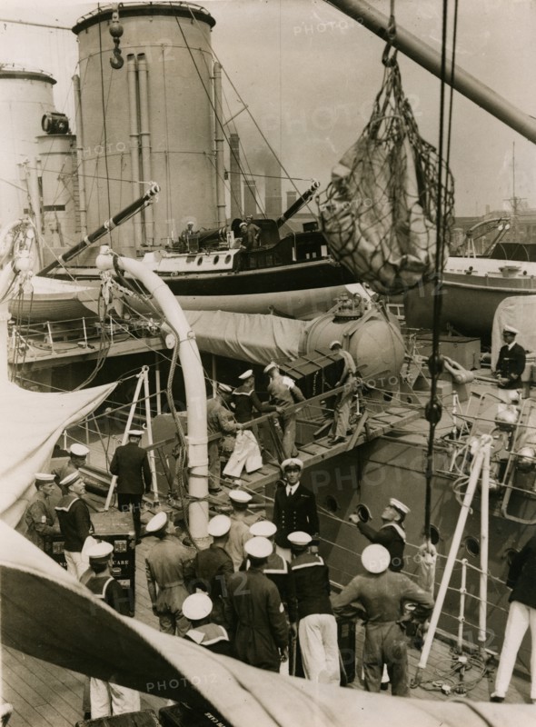 Transfering cases from H.M.S. Suffolk to H.M.S. Hood at Portsmouth, July 1935. Creator: Topical Press Agency.