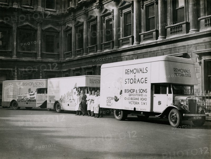 Sir Walter Lamb with vans and staff from Bishop & Sons Depositories outside Burlington House, 1935. Creator: Topical Press Agency.