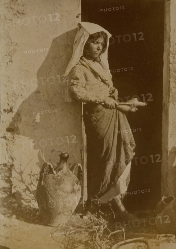 Young woman holding spindles, probably Taormina, Sicily, c1890s. Creator: Count Wilhelm von Gloeden.