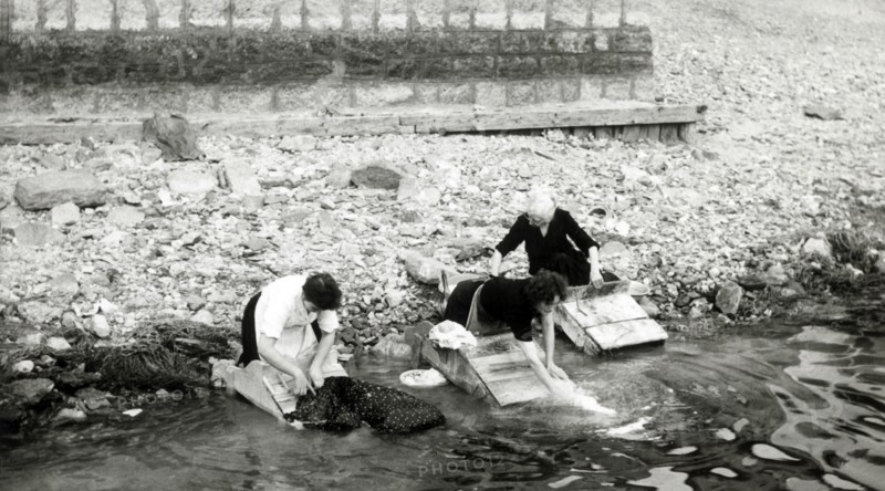 Women washing clothes on the shore of Lago Maggiore, Isola Bella, Italy, c1955.  Creator: Arthur Charles Kirby Ware.