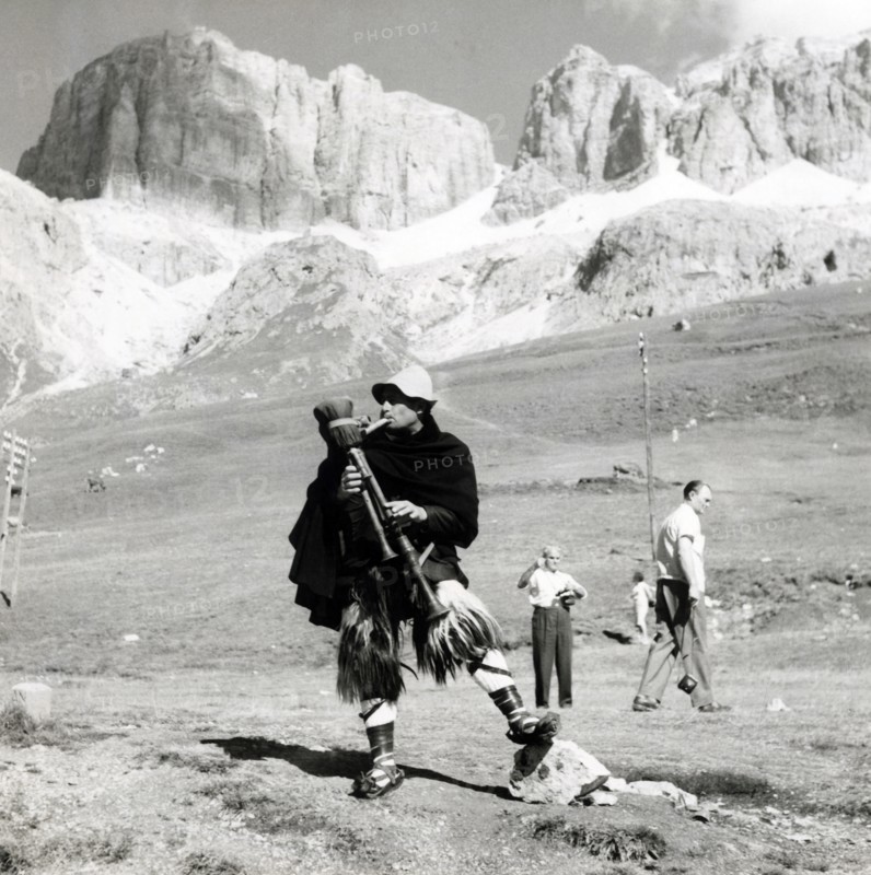 Man in traditional costume playing the zampogna (bagpipes), Sasso Pordoi, Dolomites, Italy, c1955. Creator: Arthur Charles Kirby Ware.