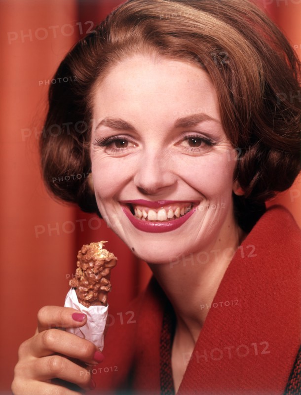 Model eating chocolate bar, c1955. Creator: Arthur Charles Kirby Ware.