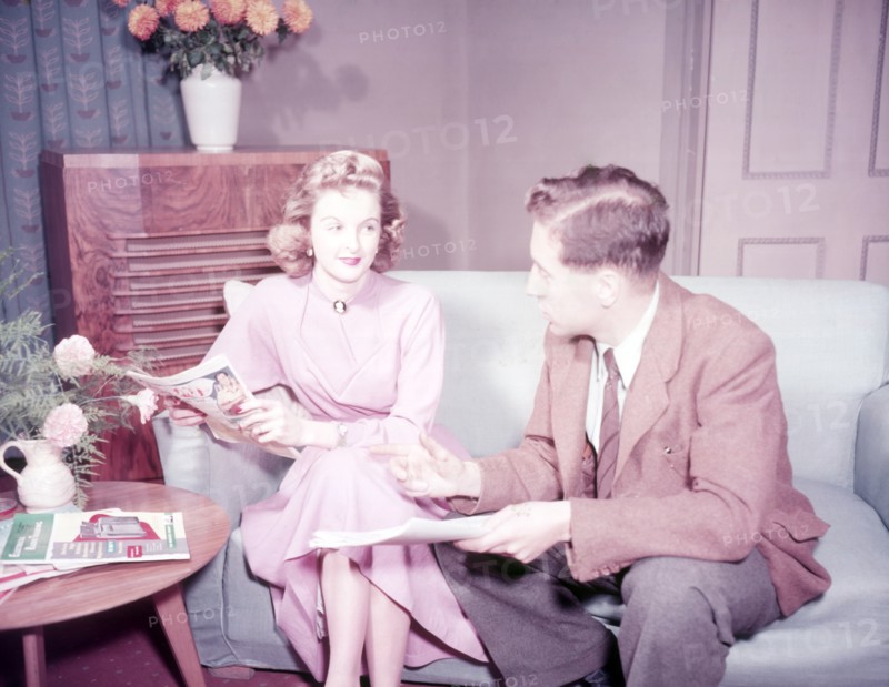 Couple sitting on sofa, c1955. Creator: Arthur Charles Kirby Ware.