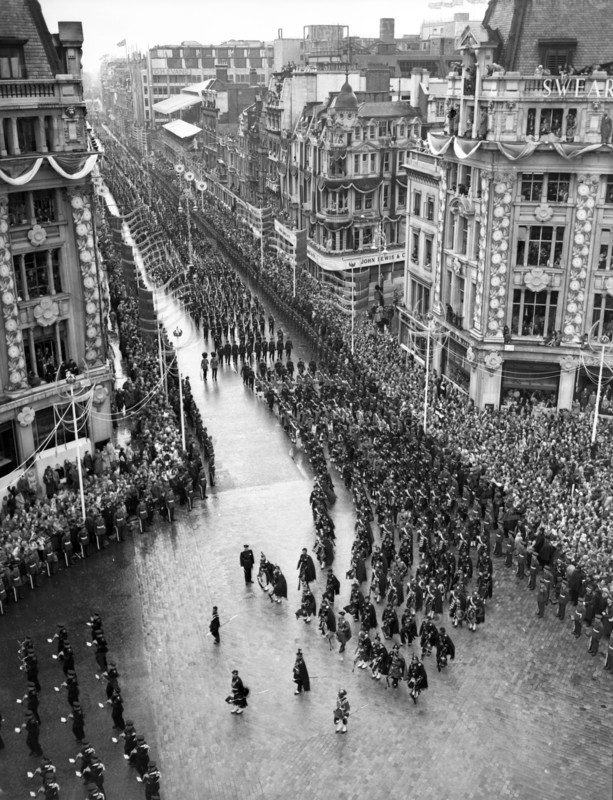 Crowds watching the coronation procession of Queen Elizabeth II, Oxford Circus, London, 2 June 1953. Creator: Arthur Charles Kirby Ware.