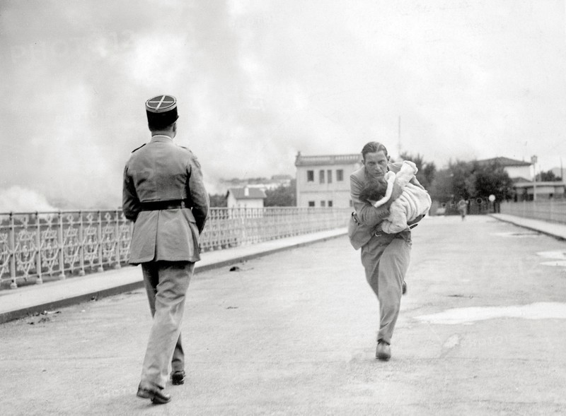 French journalist Raymond Vanker saving a baby, 1936