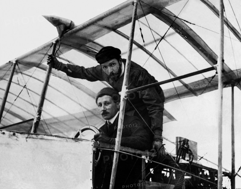 Le 28 mars 1908, sur le terrain d'Issy-les-Moulineaux, Léon Delagrange emmenant Henri Farman  à bord d'un biplan Voisin pour le premier vol avec passager.