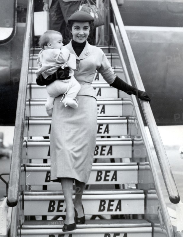 Elizabeth TAYLOR gets off the plane with her son