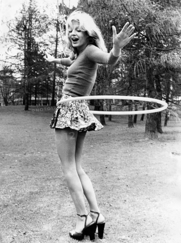 young woman playing the hula hoop