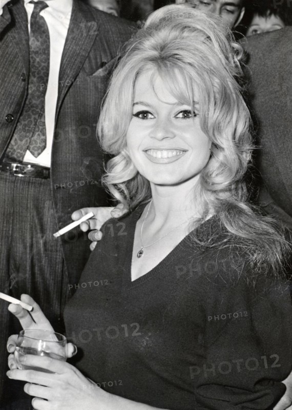 Brigitte BARDOT, portrait with cigarette and drinking glass