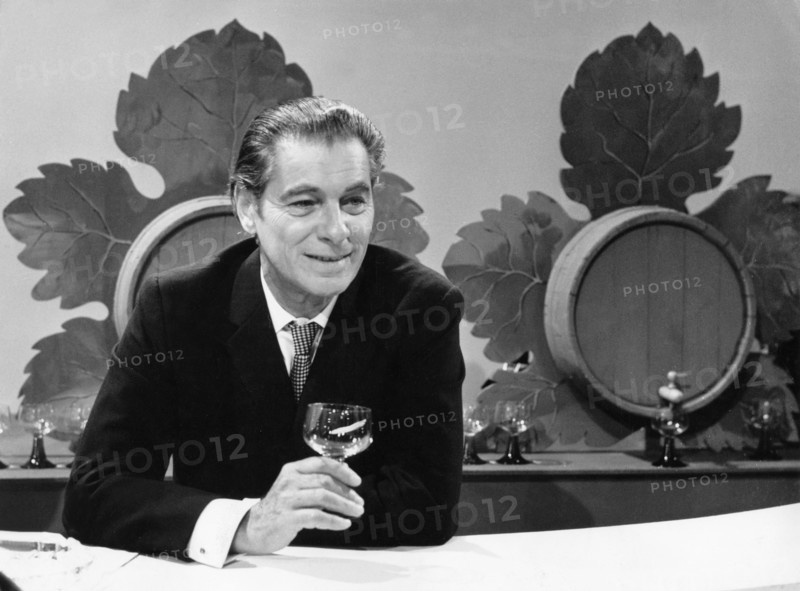 Rudolf PRACK at a wine stand, undated