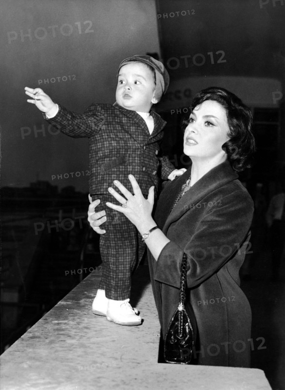 Gina LOLLOBRIGIDA with her son Milko at the airport