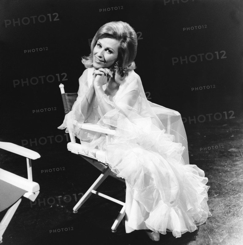 Bibi JOHNS in a director's chair