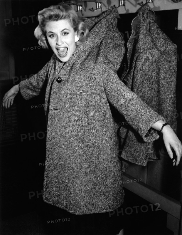 Bibi JOHNS hangs on a coat rack