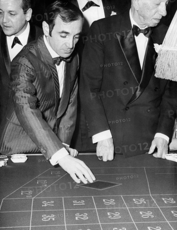 Charles AZNAVOUR at 'Maxim's' playing roulette, Paris circa 1960s