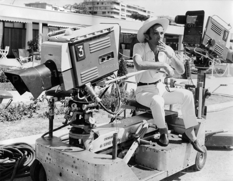 Charles AZNAVOUR smokes on a camera dolly, 1968
